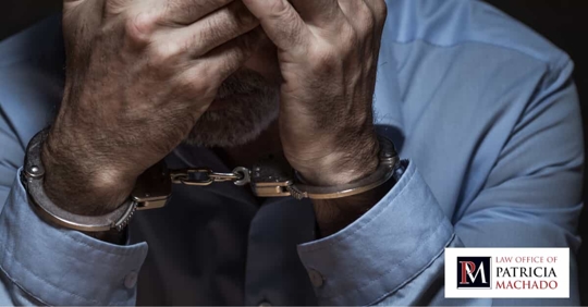 A worried man in handcuffs