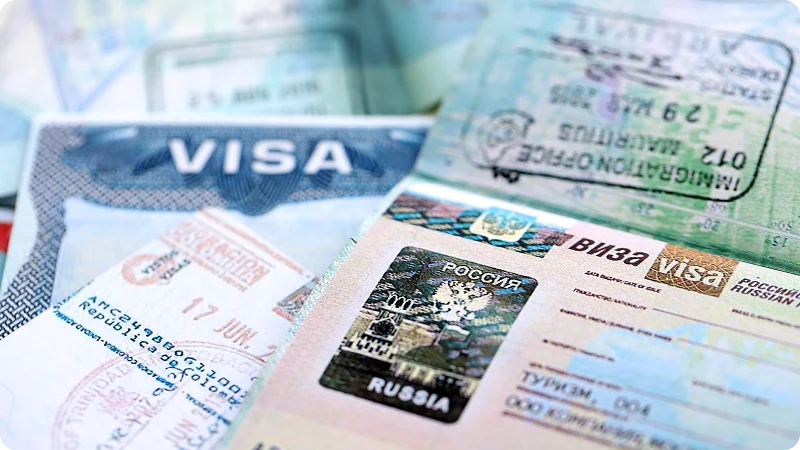 Close-up of passport pages with various international visas and stamps.