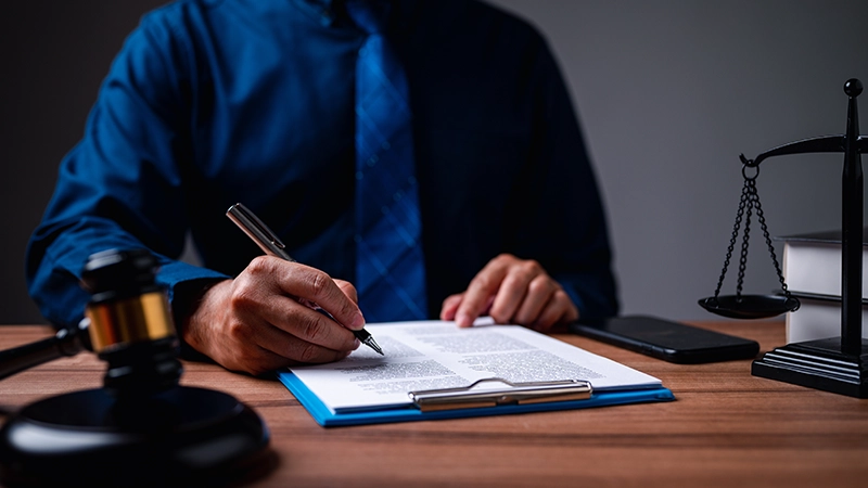 The immigration officer brought down the gavel of justice on the table.