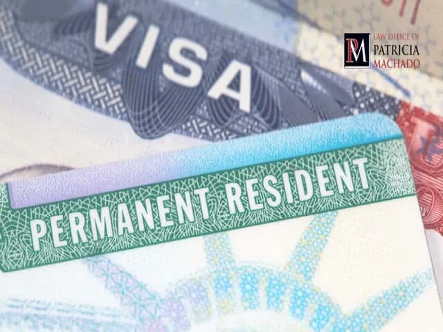 A U.S. Permanent Resident card overlaid on a blurred Visa document.