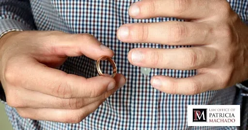 Hombre quitándose el anillo de bodas mientras se prepara para el divorcio